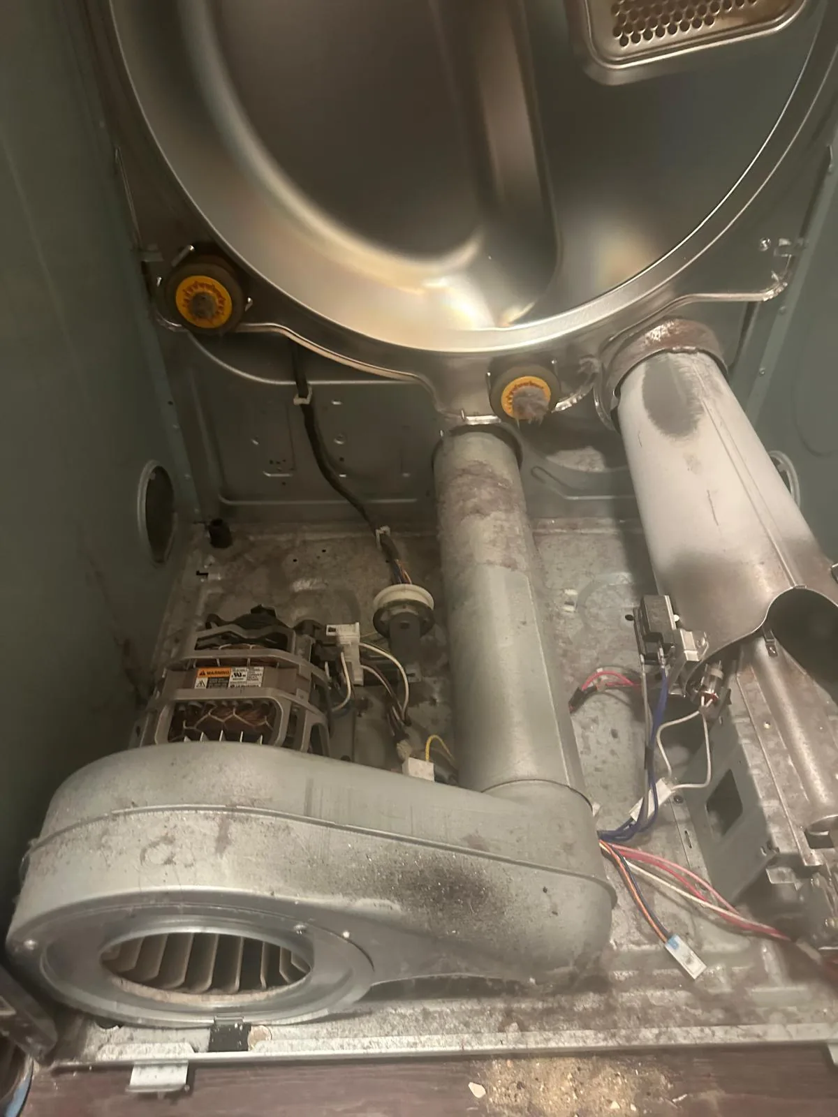 LG dryer opened up with the drum, belt and blower assembly exposed for idler pulley diagnosis