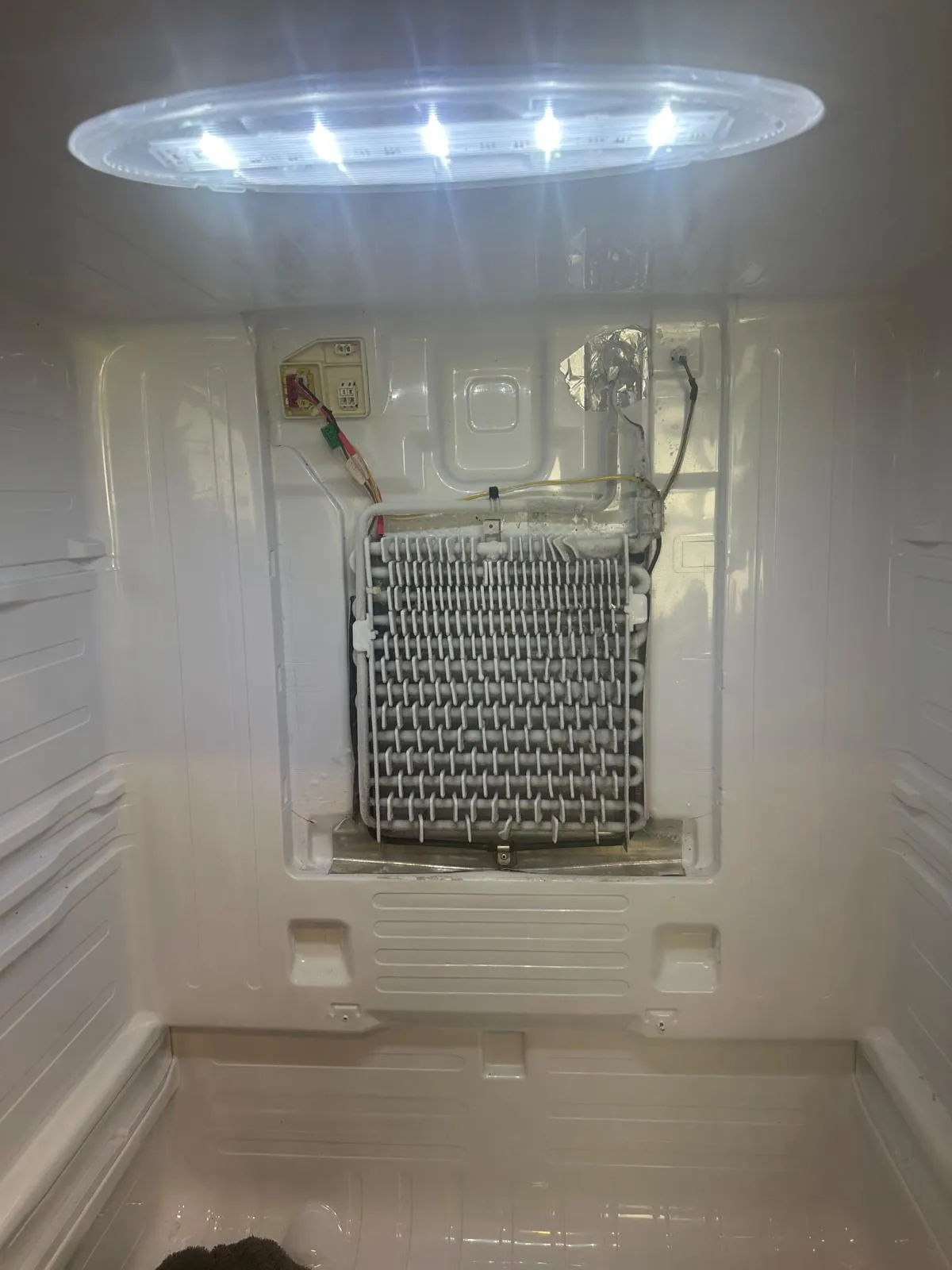 Samsung refrigerator evaporator coils clear of ice after fan motor replacement and drain line defrost