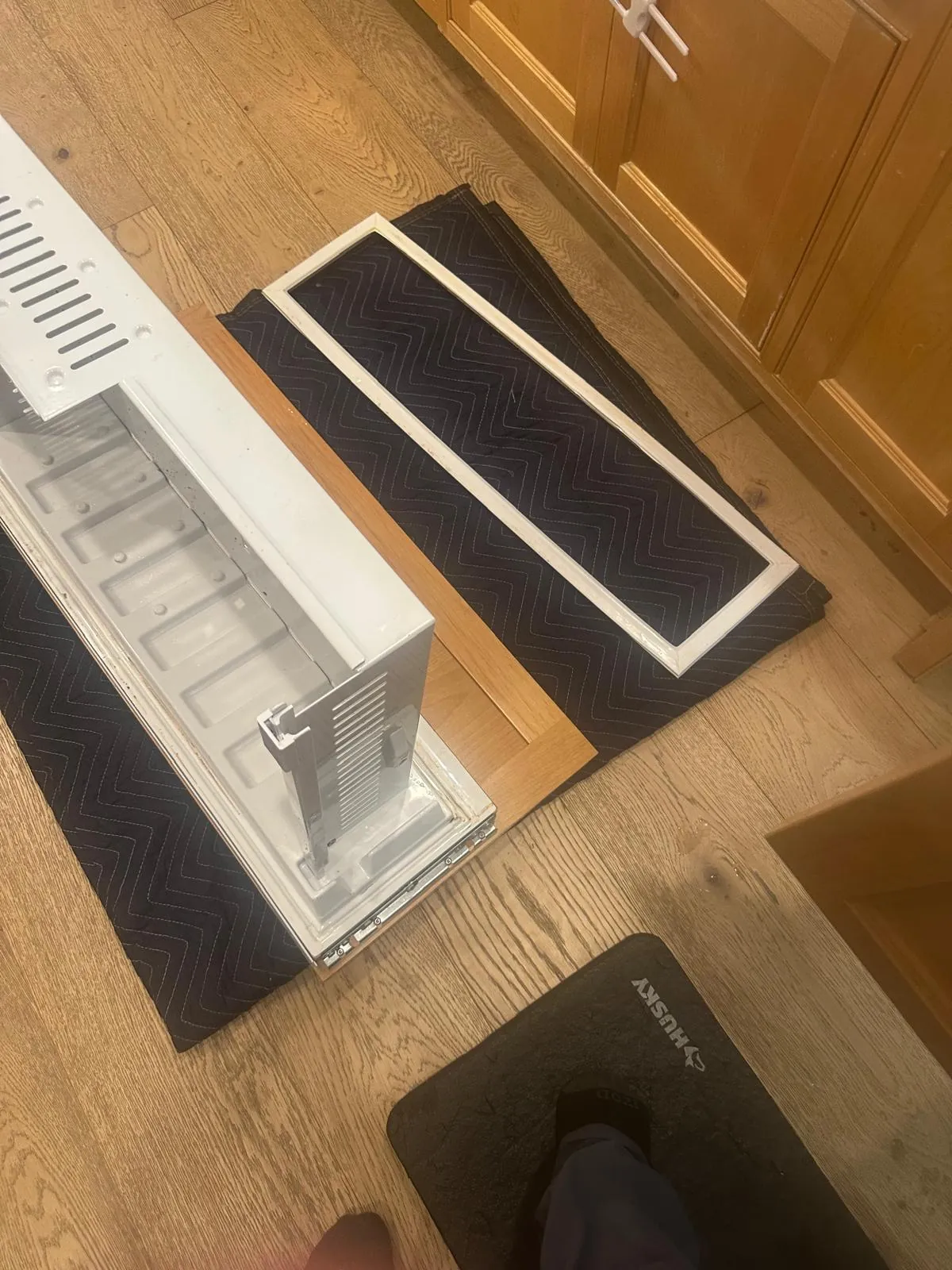 Sub-Zero freezer door panel and old gasket frame removed during gasket replacement