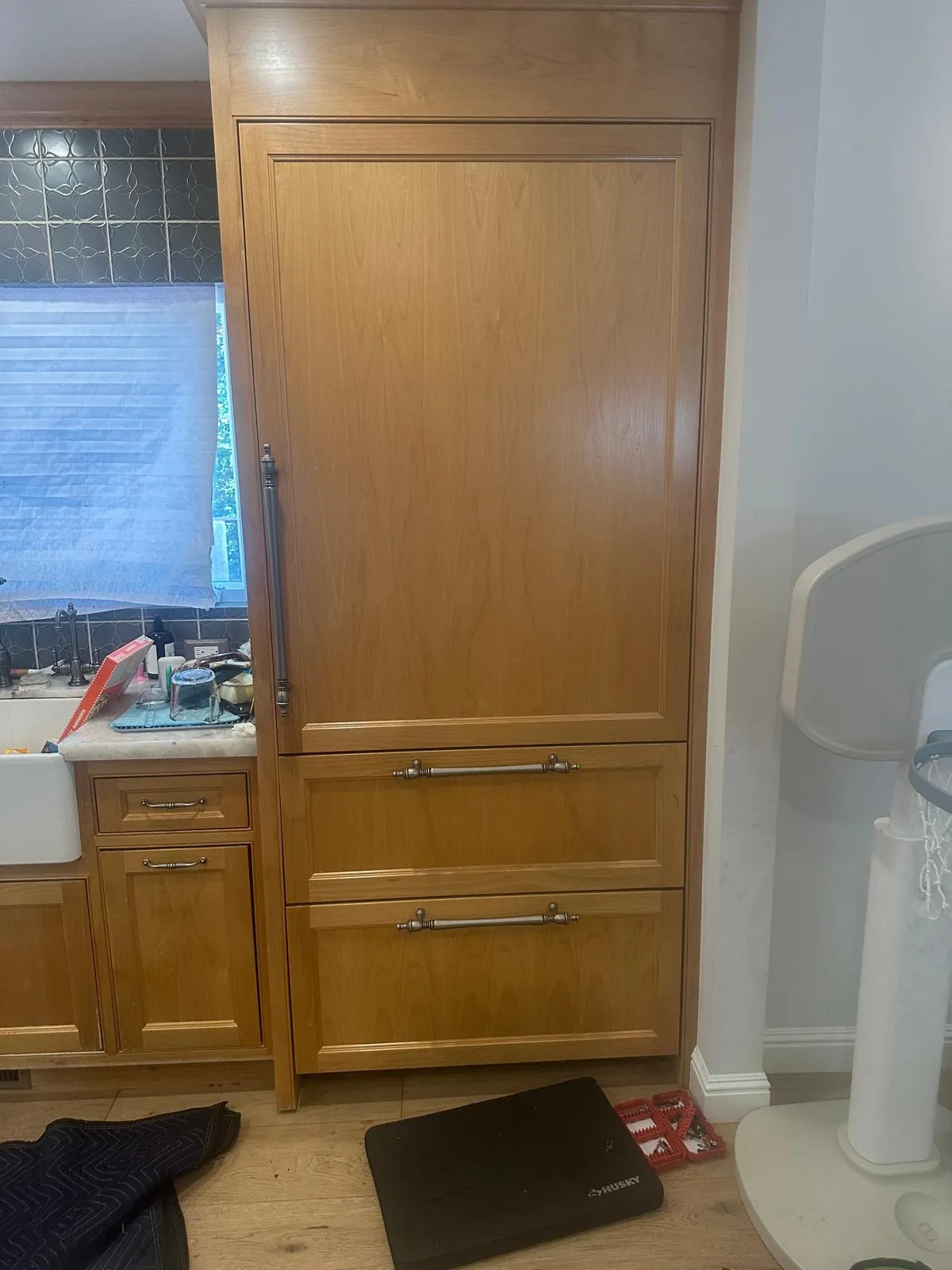 Built-in Sub-Zero refrigerator with wood panel doors before freezer door gasket replacement