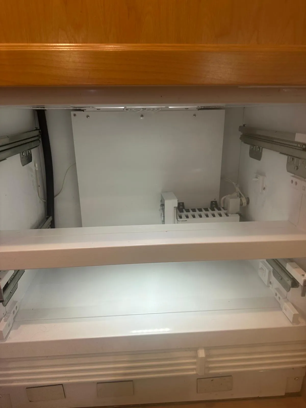 Sub-Zero freezer compartment reassembled with coil cover repaired and door sealing properly